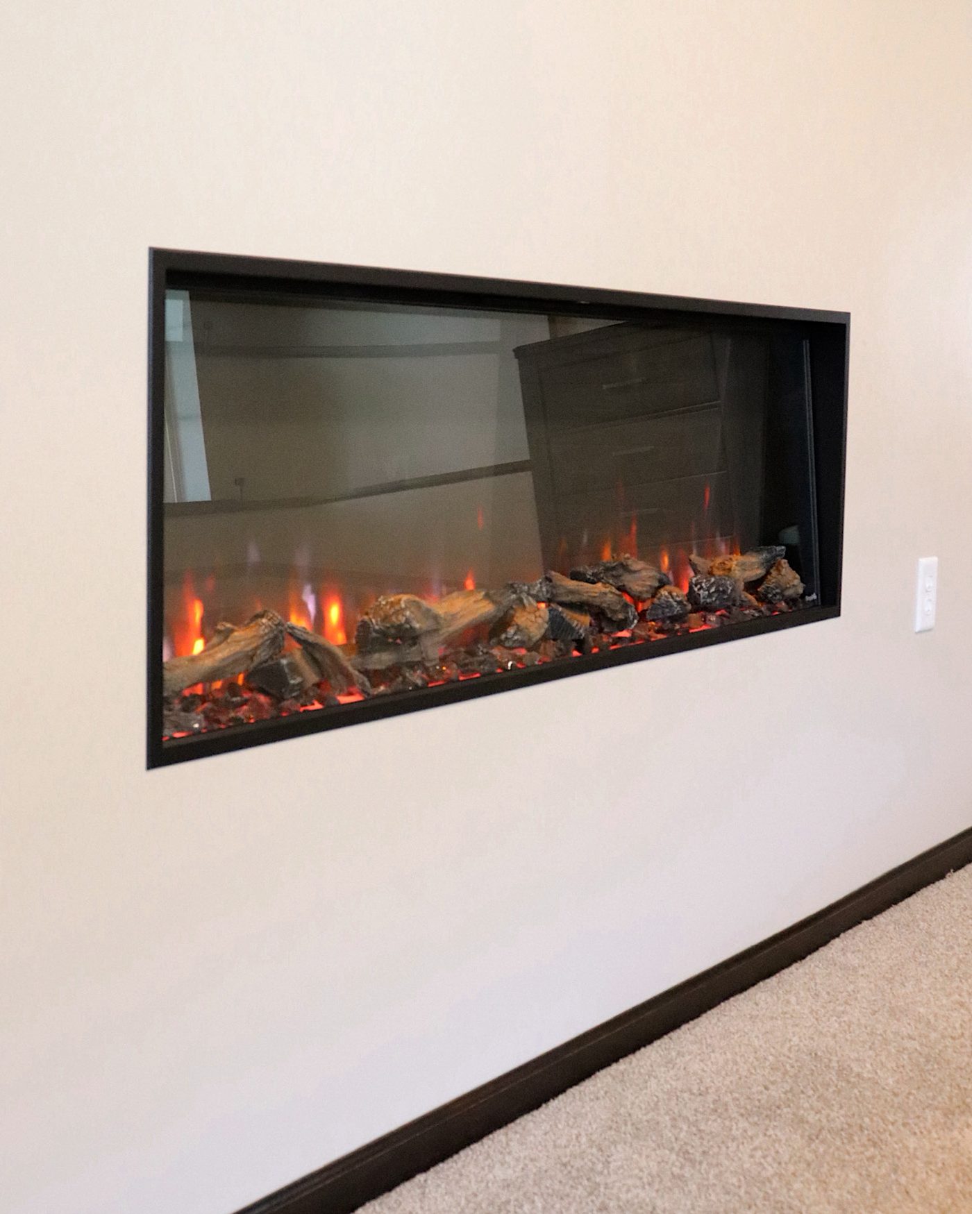 Built-in linear electric fireplace detail from a basement remodel