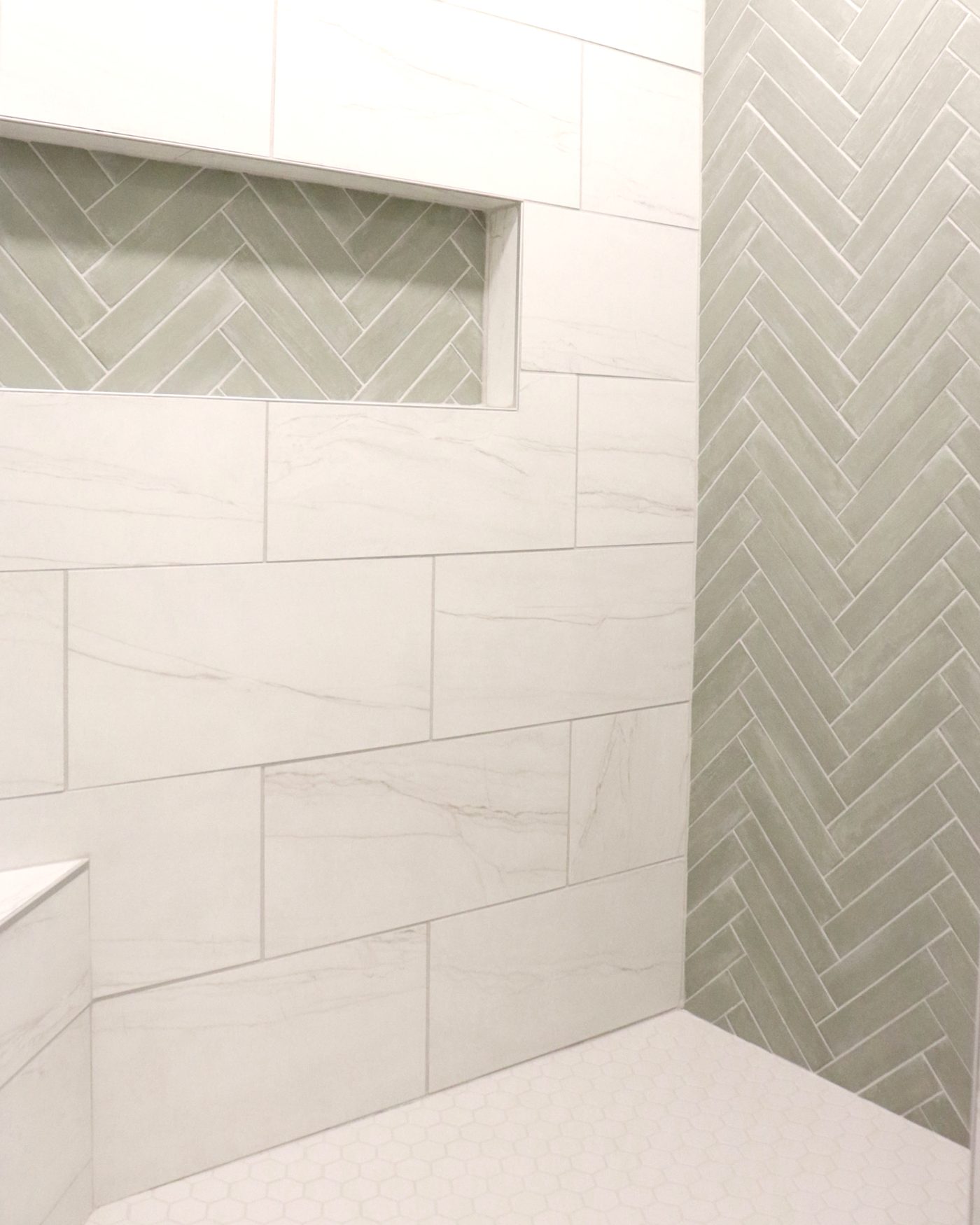 Custom herringbone tile shower niche installed by NK Construction